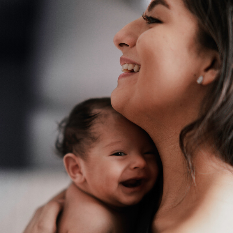 Happy mom holding smiling baby